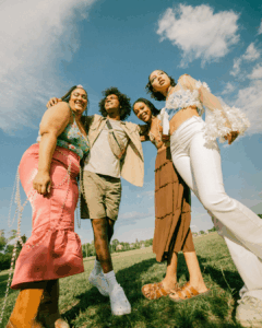 Four friends posing for a picture at a music festival